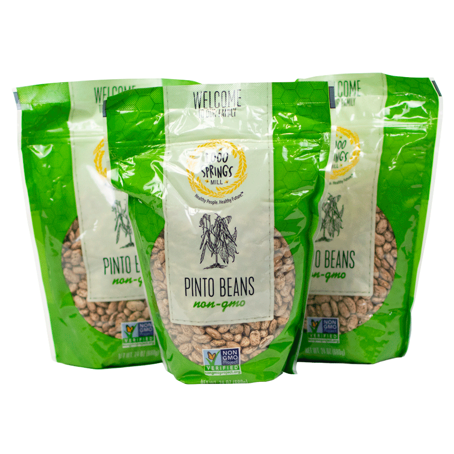 Three green bags of pinto beans with 1000 Springs Mill logo on the front
