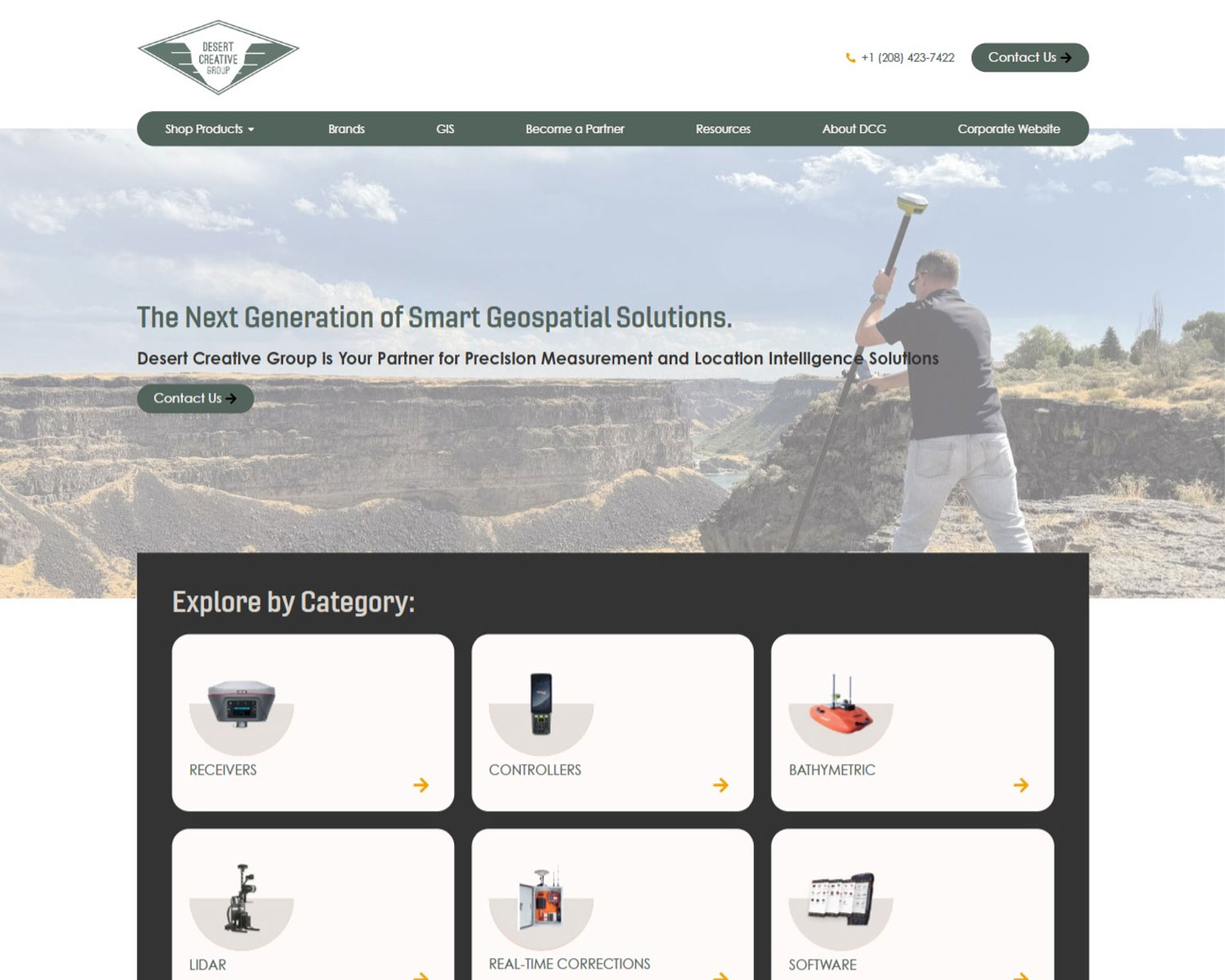 Screenshot of a website homepage for Desert Creative Group showcasing geospatial products and categories like receivers, controllers, bathymetric equipment, LiDAR, corrections, and software. A person surveys land in the banner image.